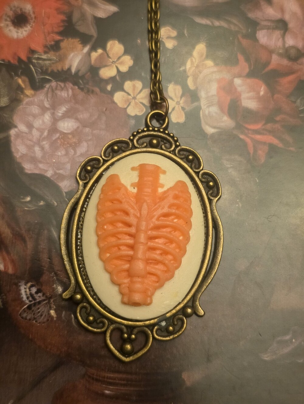 Pink Ribcage On Cream.backdrop On Bronze Frame & Chain Necklace